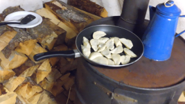 Cooking on the barrel stove.png
